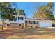 Charming home boasts a brick and vinyl facade, enhanced by black shutters and a manicured lawn at 6071 Cristie Dr, Ellenwood, GA 30294