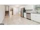 A bright kitchen features stainless steel appliances, granite countertops, and white cabinets at 6071 Cristie Dr, Ellenwood, GA 30294