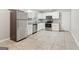 A well-lit kitchen features stainless steel appliances, granite countertops and white cabinets at 6071 Cristie Dr, Ellenwood, GA 30294