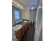 Bathroom featuring double sinks, dark wood cabinets, and modern lighting at 5425 Twin Lakes Dr, Atlanta, GA 30349