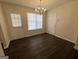 Bright dining area featuring dark floors, a chandelier, and access to the backyard at 5425 Twin Lakes Dr, Atlanta, GA 30349