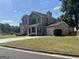 Attractive two-story home with a front porch, attached garage, well-maintained lawn and professional landscaping at 5425 Twin Lakes Dr, Atlanta, GA 30349