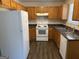 Functional kitchen with white appliances, wood cabinets, and a stainless steel sink at 5425 Twin Lakes Dr, Atlanta, GA 30349