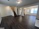 Spacious living room with dark floors, stairway, and an open floor plan to the dining area at 5425 Twin Lakes Dr, Atlanta, GA 30349