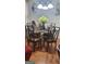 Cozy dining room features a glass table, seating for six, and warm wood floors at 1923 Manhattan Pkwy, Decatur, GA 30035