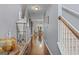 Bright hallway with hardwood floors, elegant decor, and a staircase leading to upper level at 6870 Diamond Dr, Rex, GA 30273