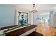 Bright dining area featuring a rustic table, bench seating, and seamless flow to the kitchen at 75 Wellington Dr, Mcdonough, GA 30252