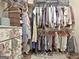 Well-organized closet with clothing, storage shelves, and painted dresser at 220 Brock Ct, Fayetteville, GA 30215