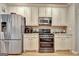 Modern kitchen equipped with stainless steel appliances and light colored cabinets at 220 Brock Ct, Fayetteville, GA 30215