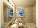 Bright bathroom with a marble-tiled shower, granite countertop vanity, and updated fixtures at 3376 Brookfield Ln, Decatur, GA 30032