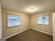 Neutral bedroom with carpet, tan walls, and two windows covered with white blinds at 3376 Brookfield Ln, Decatur, GA 30032