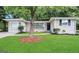 Charming single-story home with a well-maintained lawn and a classic brick facade, nestled among mature trees at 3376 Brookfield Ln, Decatur, GA 30032