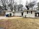 Single-story home featuring a classic brick facade and mature trees, awaiting personal touches to restore its charm at 3376 Brookfield Ln, Decatur, GA 30032