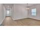 Dining area featuring wood-look flooring and an elegant chandelier at 654 Egrets Lot 65 Lndg # 65, Covington, GA 30014