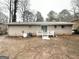 Exterior backyard view featuring white brick and a white deck at 2683 Terratim Ln, Decatur, GA 30034
