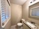 Bathroom featuring granite vanity, mirror, toilet, and window for natural light at 2683 Terratim Ln, Decatur, GA 30034
