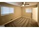 Cozy bedroom featuring neutral carpet, ceiling fan, and natural light from the window at 2683 Terratim Ln, Decatur, GA 30034