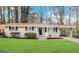 Charming single-story home with a manicured lawn, carport and mature trees at 2683 Terratim Ln, Decatur, GA 30034