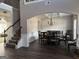 Dining room featuring an archway, chandelier, and hardwood floors, adjacent to a staircase at 39 Hannah Way, Palmetto, GA 30268