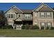 Charming two-story home with brick and gray siding, a well-manicured lawn, and a welcoming front entrance at 39 Hannah Way, Palmetto, GA 30268
