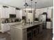 Spacious kitchen featuring white cabinets, granite counters, a central island with seating and modern stainless steel appliances at 39 Hannah Way, Palmetto, GA 30268