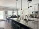 Kitchen with a granite countertop island, stainless steel appliances, and an adjacent dining area with backyard view at 39 Hannah Way, Palmetto, GA 30268