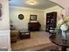 Cozy living room featuring neutral walls, a piano, a bookcase, and comfortable seating at 39 Hannah Way, Palmetto, GA 30268