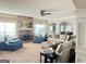Open-concept living room featuring a cozy fireplace, plush seating, and a view into the dining area at 39 Hannah Way, Palmetto, GA 30268