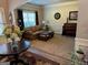 Comfortable living room with a view of the window, a piano, and hardwood floors at 39 Hannah Way, Palmetto, GA 30268
