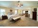 Spacious main bedroom with ceiling fan, sitting area, neutral colors, large windows and carpet flooring at 39 Hannah Way, Palmetto, GA 30268