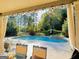 Inviting backyard pool with an adjacent hot tub, surrounded by lush greenery and a charming fence at 39 Hannah Way, Palmetto, GA 30268