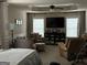 Relaxing sitting area in the main bedroom with a large TV, comfortable chairs, carpet and ample light at 39 Hannah Way, Palmetto, GA 30268