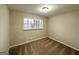 Cozy bedroom with neutral walls, plush carpet, and a window providing natural light at 2296 Aurie Dr, Decatur, GA 30034