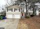 Charming two-story home with a brick facade, attached garage, and mature landscaping at 2296 Aurie Dr, Decatur, GA 30034
