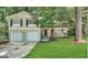 Charming two-story home with a brick facade, attached garage, and a well-manicured lawn at 2296 Aurie Dr, Decatur, GA 30034