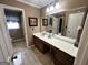 Bathroom featuring a spacious vanity, large mirror, and tiled flooring at 160 Appalachee Church Rd, Auburn, GA 30011
