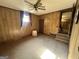Wood paneled bedroom with a ceiling fan, carpet, and a small side table at 160 Appalachee Church Rd, Auburn, GA 30011