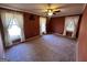 Bedroom with a ceiling fan, carpeting, windows with curtains, and wallpapered walls at 160 Appalachee Church Rd, Auburn, GA 30011