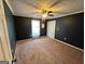 Bedroom with dark blue walls, carpeted floor, ceiling fan, and closet at 160 Appalachee Church Rd, Auburn, GA 30011