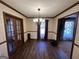 Formal dining room featuring wood floors, chandelier lighting, and french doors at 160 Appalachee Church Rd, Auburn, GA 30011