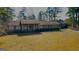 Traditional brick home featuring an expansive front yard with mature trees and a charming entryway at 160 Appalachee Church Rd, Auburn, GA 30011