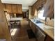 Traditional kitchen featuring wood cabinets, stainless steel appliances, and bar seating area at 160 Appalachee Church Rd, Auburn, GA 30011