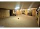 Cozy living room featuring wood paneling, a stone fireplace, and carpet flooring at 160 Appalachee Church Rd, Auburn, GA 30011