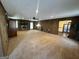 A spacious living room with cozy fireplace, wood walls, and neutral carpet at 160 Appalachee Church Rd, Auburn, GA 30011