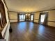 Large living room featuring hard wood floors, trim detail, and chandelier lighting at 160 Appalachee Church Rd, Auburn, GA 30011