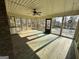 Bright sunroom with wood-look flooring, a ceiling fan, and multiple windows offering outdoor views at 160 Appalachee Church Rd, Auburn, GA 30011