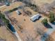 Aerial view of a property with multiple buildings and mature trees at 382 Lamb Rd, Moreland, GA 30259