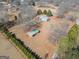Aerial view of a spacious property with mature trees and a fenced perimeter at 382 Lamb Rd, Moreland, GA 30259