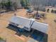 Aerial view of the home highlighting the metal roof, outbuildings and covered parking at 382 Lamb Rd, Moreland, GA 30259