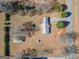 Birds-eye view of property with multiple outbuildings and mature trees at 382 Lamb Rd, Moreland, GA 30259